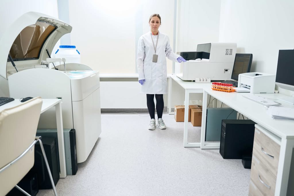 A healthcare provider in a white coat standing in a fully equipped clinical facility optimized as a private office space for home health care administration and medical oversight in Houston, Texas.