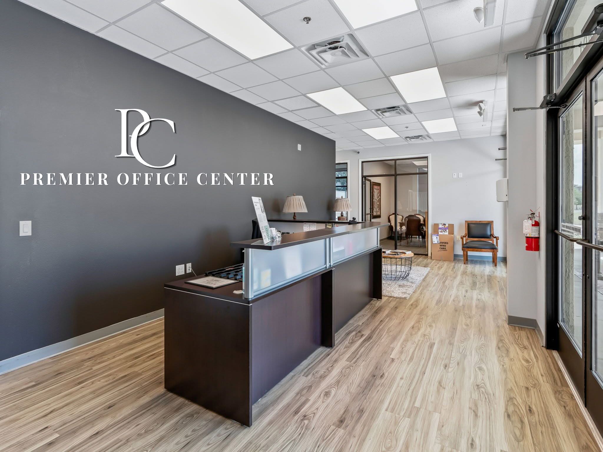 Modern reception area and desk at Premier Office Center offering professional office suites in Wildwood, FL.