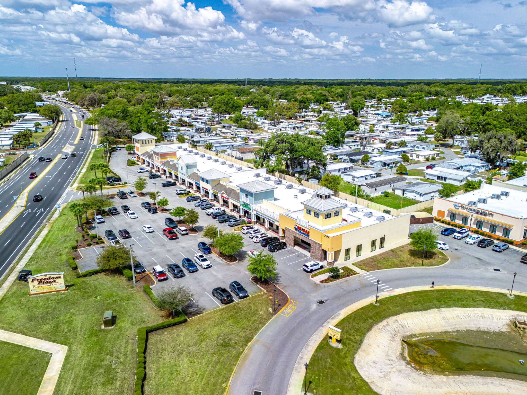 Aerial view of the commercial plaza housing Premier Office Center and professional office suites in Wildwood, FL.