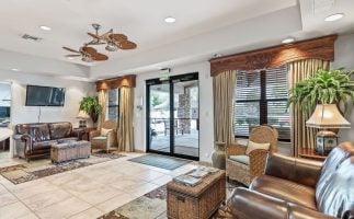 Hotel lobby featuring leather furniture and a ceiling fan, creating a stylish and comfortable atmosphere for guests. That is good thing to create some blogs with terms and conditions