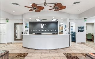 Front desk of the premier coffee center, featuring a sleek design and a barista ready to assist customers and contact us.