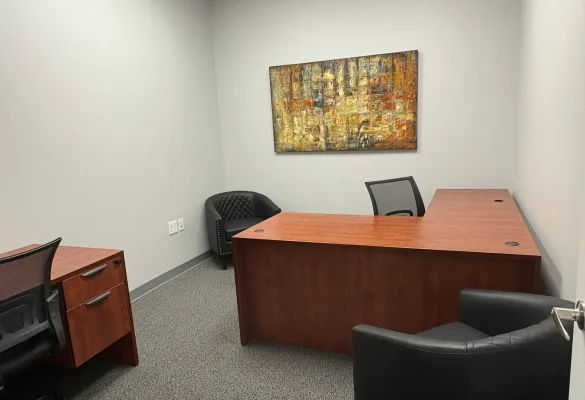 friendly receptionist greeting a client inside a Central Florida office space with receptionist services