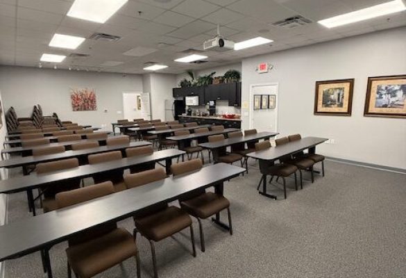private office for salesperson with glass walls and desk setup in Ocala coworking space