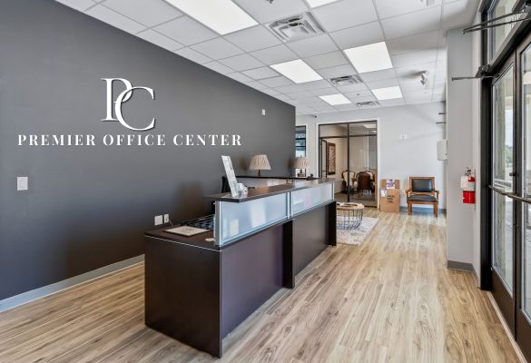 Modern reception area and desk at Premier Office Center offering professional office suites in Wildwood, FL.