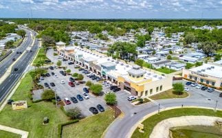 Aerial view of the commercial plaza housing Premier Office Center and professional office suites in Wildwood, FL.